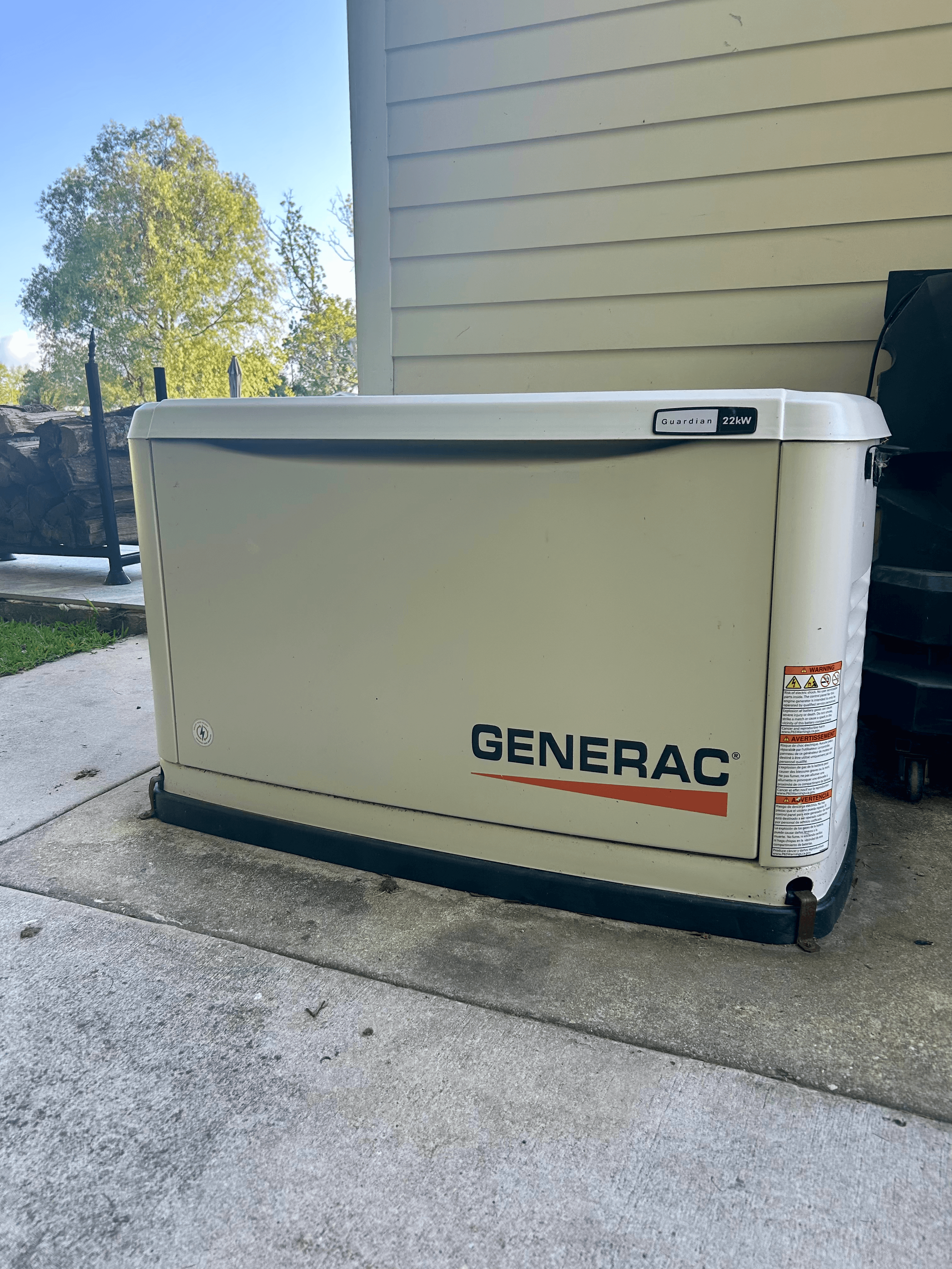 Generac Guardian 22kW standby generator installed on a concrete pad outside a residential home.